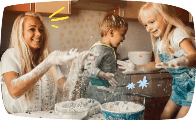 Babysitter and kids are making a mess of the kitchen as they play with flour and have fun
